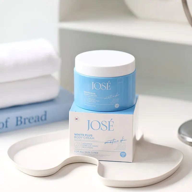 José White Plus body cream jar and packaging on a white surface
