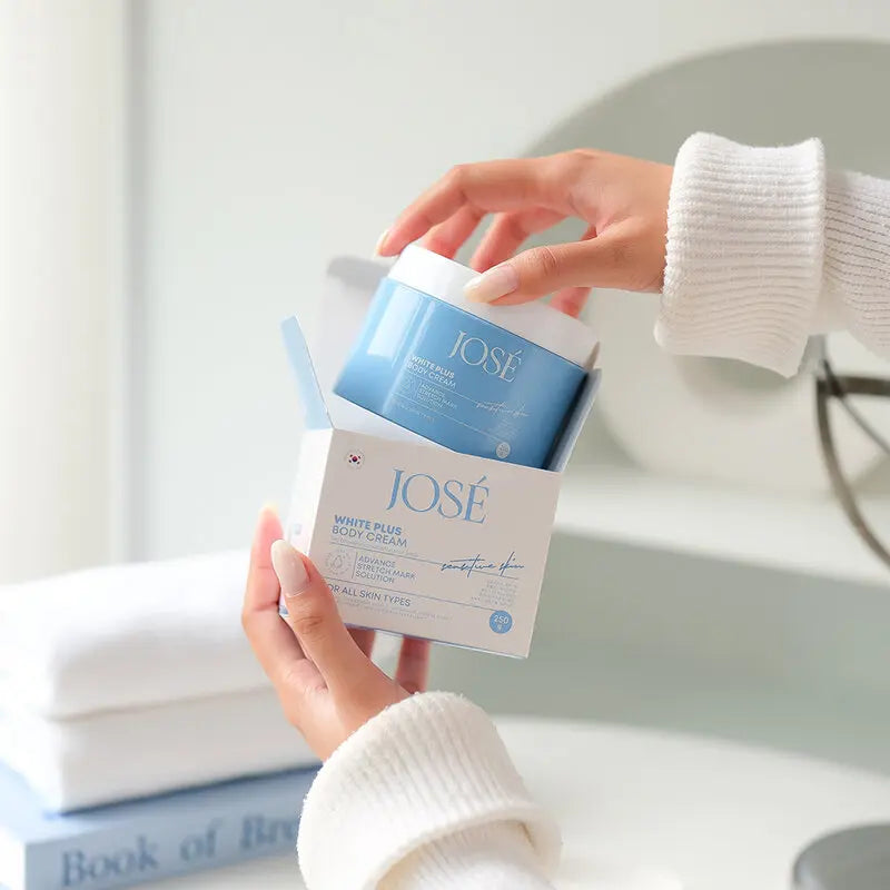 Person holding a jar of Jose body scrub in a bathroom setting