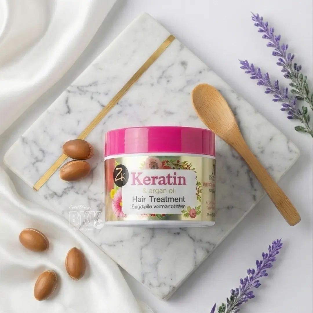 Keratin hair treatment jar with argan oil on a marble surface