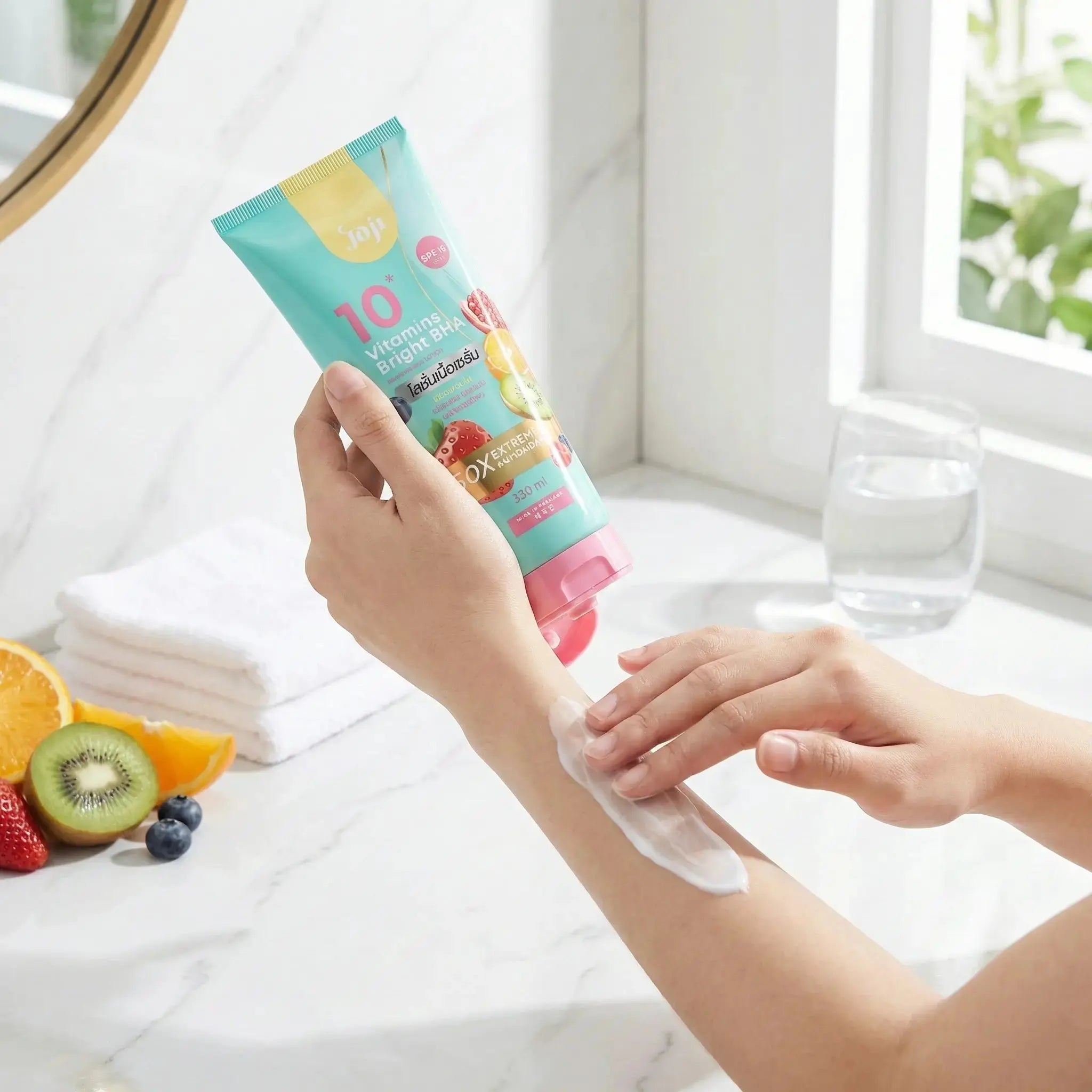 Person applying a tube of sunscreen cream to their arm in a bright bathroom.