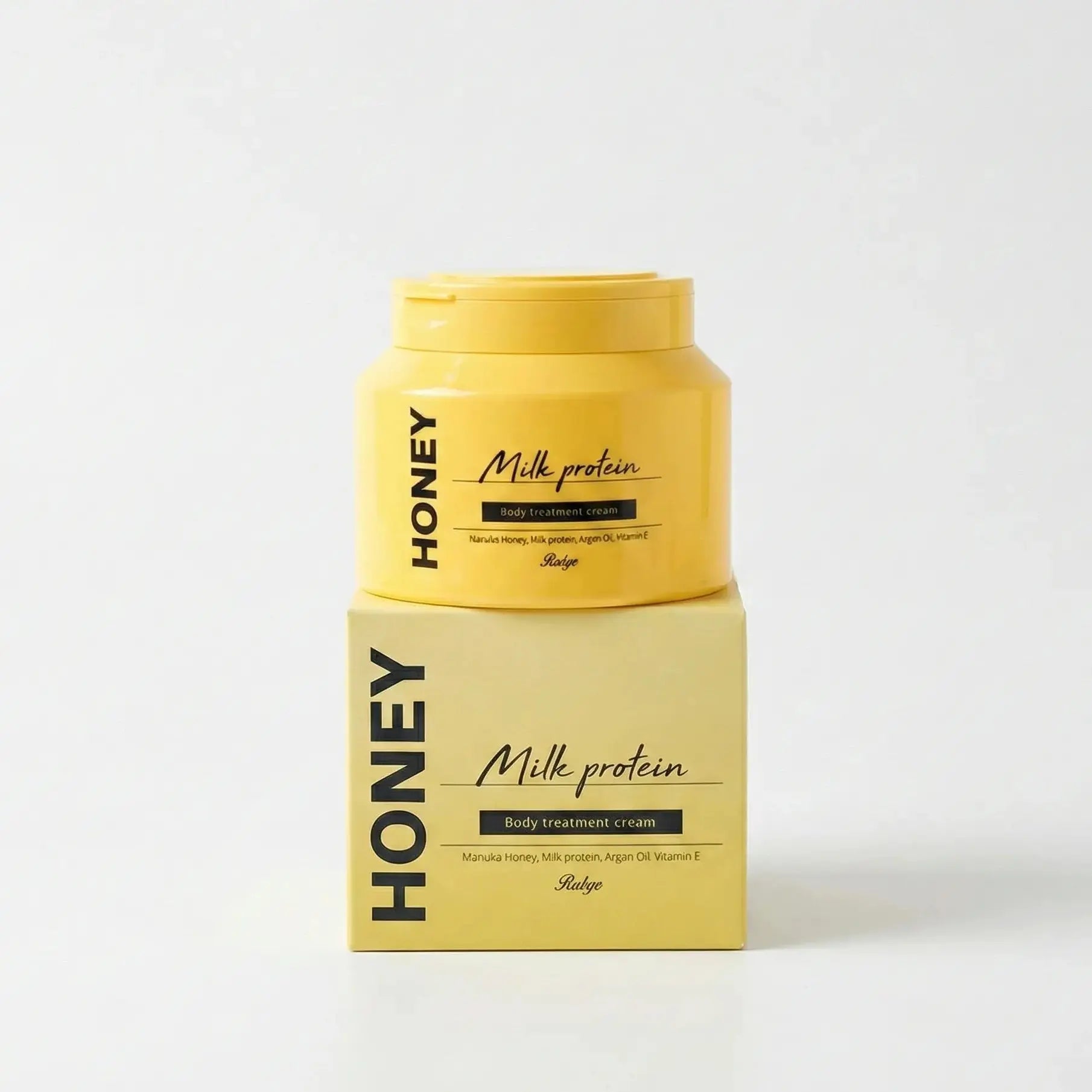 Yellow container and box of Honey Milk Protein on a white background